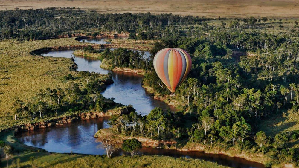 Hot air balloon, watching Africa awaken beneath you.