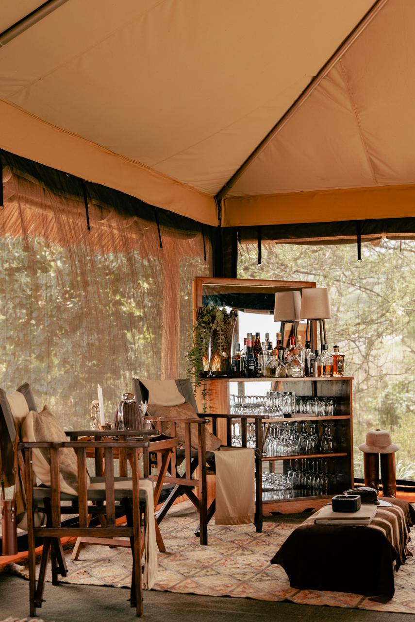 Close-up of a classic safari bar inside a canvas tent , timeless African charm and down to earth luxury.
